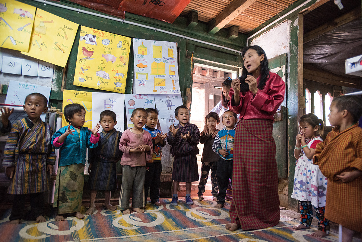 Preschool teacher Rinchen finishes up a song with her students just before she opens up the classroom’s learning corners.