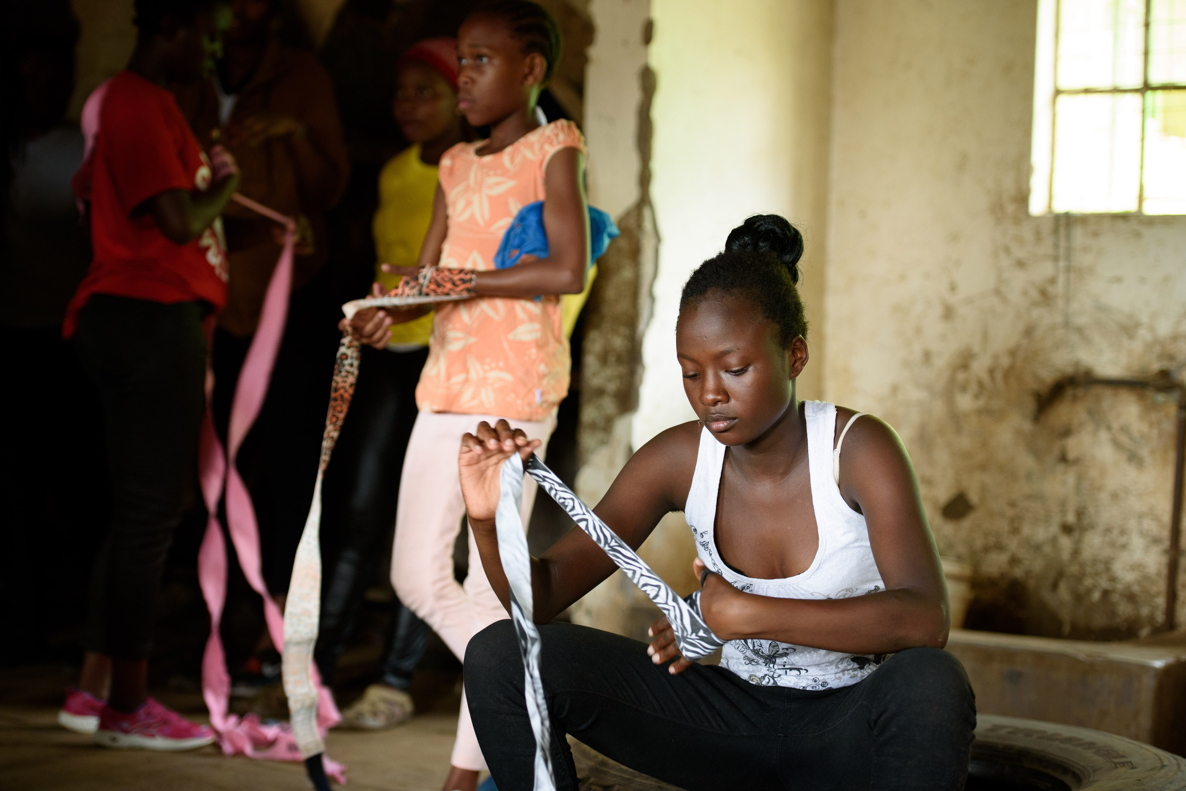 a Box Girls student wrapping her fists before practice