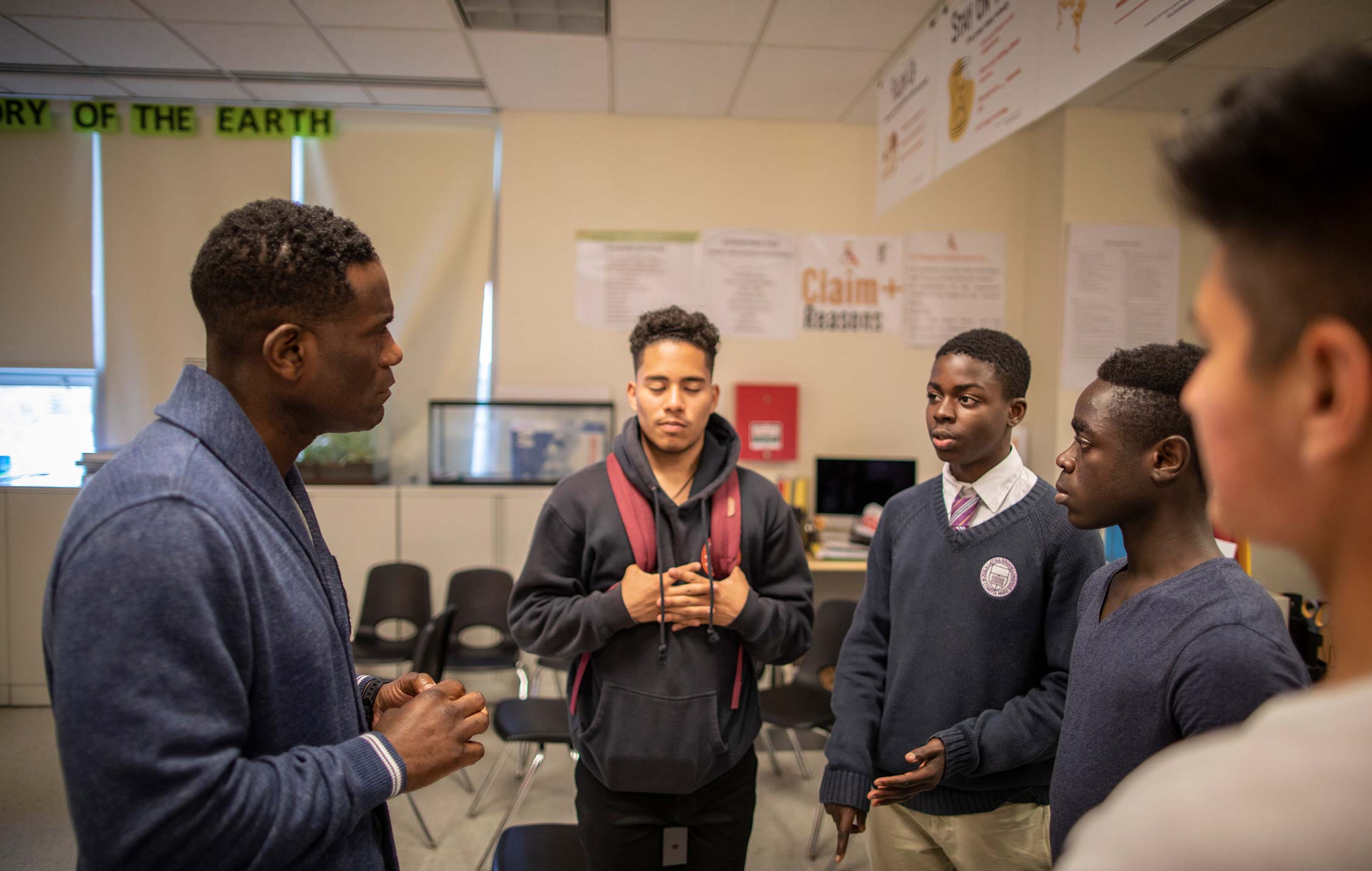 Robbie Earle, of NBC Sports, visits a project funded by Red Nose Day.